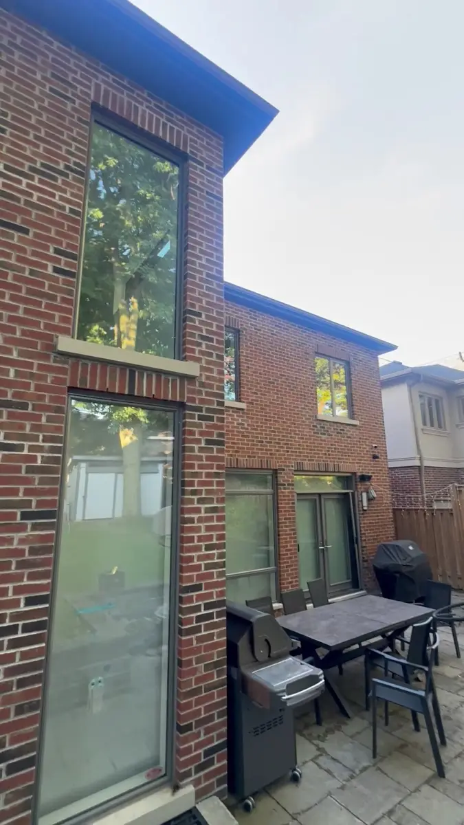 Clean exterior windows on a red-brick home